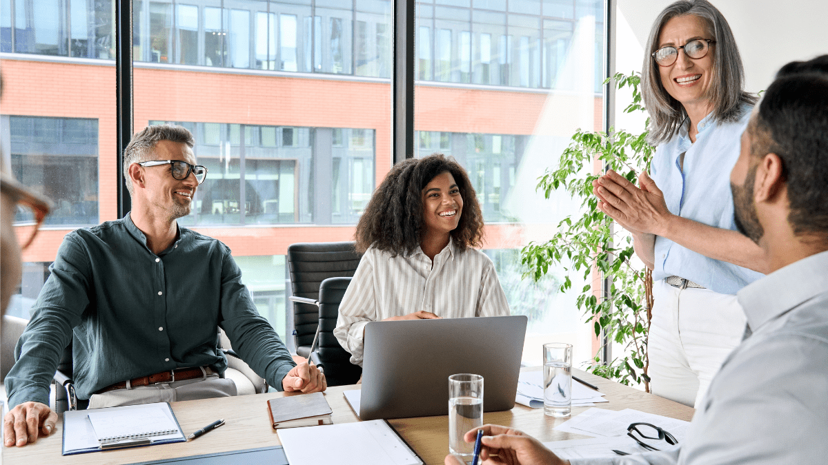 Building Trust with a Multi-Generational Workforce - professional team meeting in a modern office with floor-to-ceiling windows